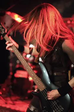Left-hand bass player with long hair covering their face.