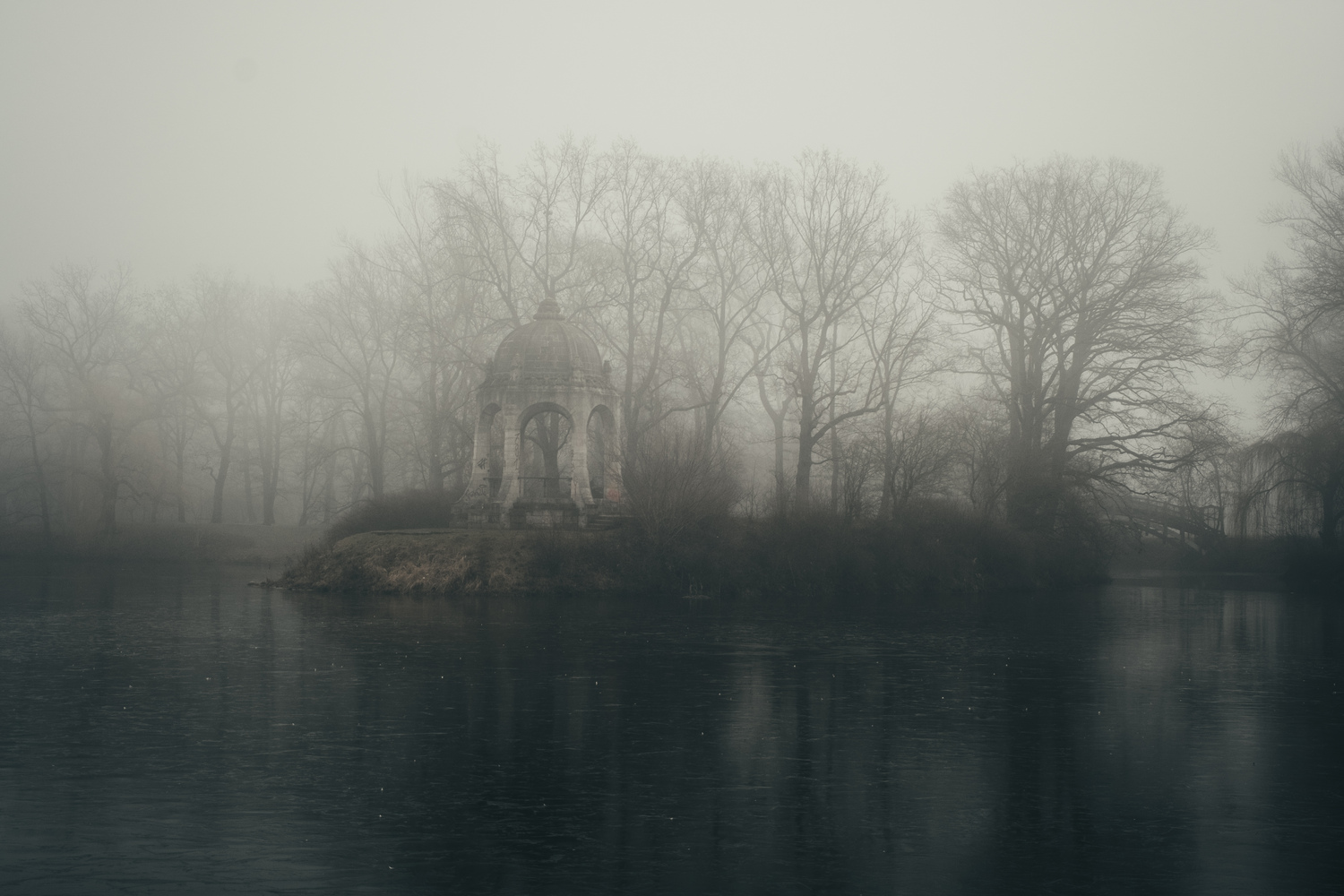 Fog covering an observation deck on a lake island.